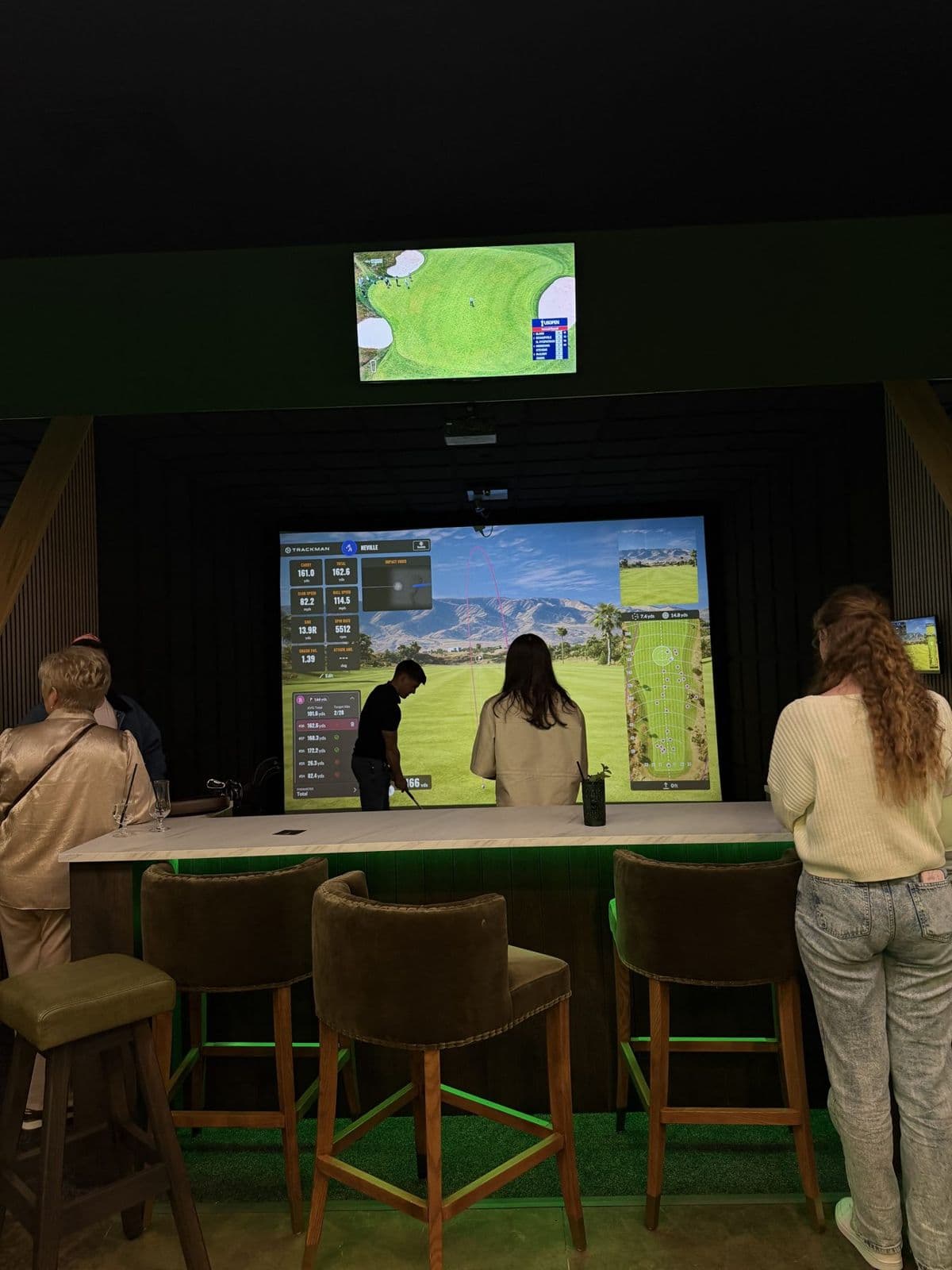 Guests watching play on the simulator screen